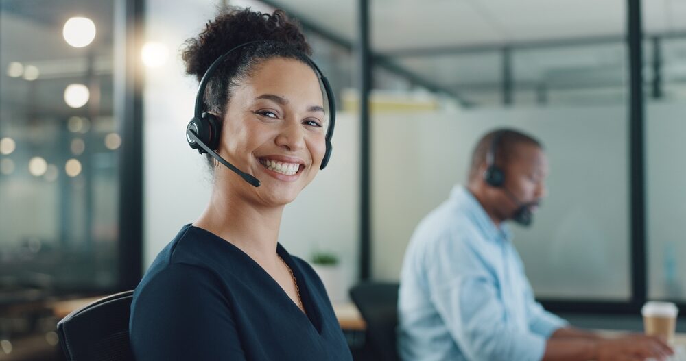 Conseiller clientèle avec casque en environnement de bureau, symbolisant l’accompagnement et le conseil pour la gestion des charges et des bâtiments chez OCEA Smart Building